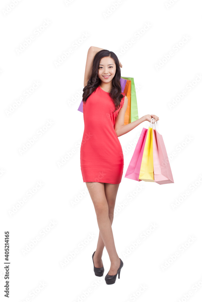 A happy Young woman holding shopping bags