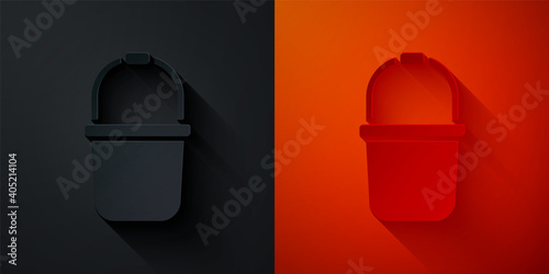 Paper cut Sauna bucket icon isolated on black and red background. Paper art style. Vector.