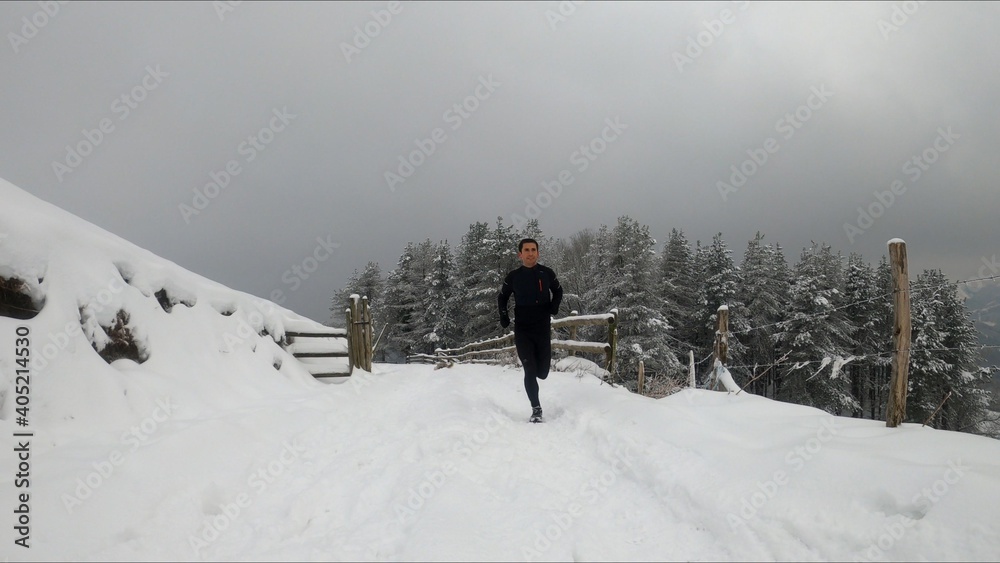 young man running in a snowed mountain