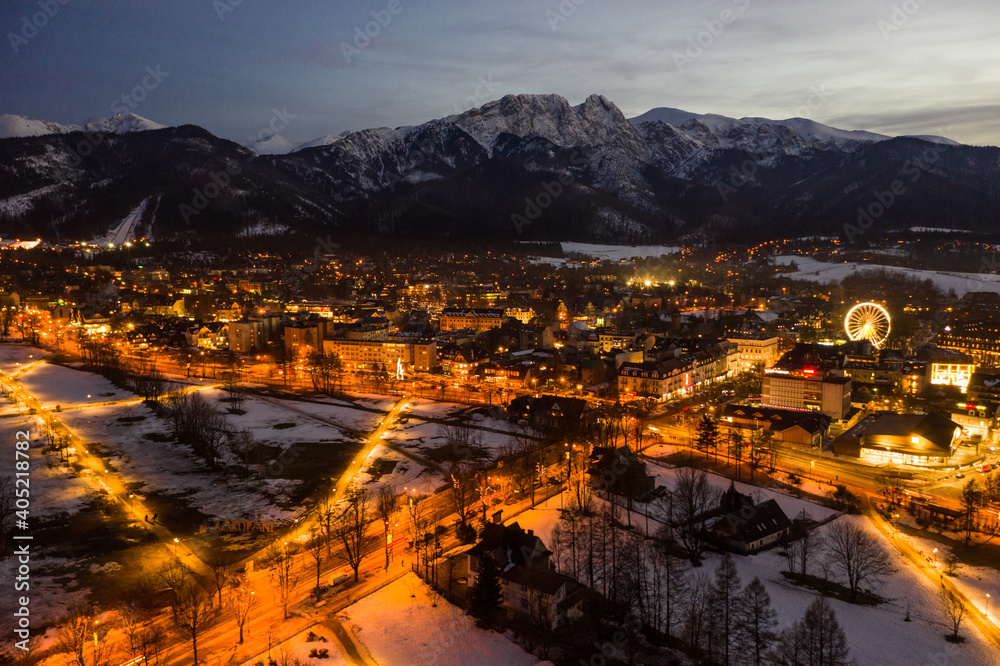 Polish mountains Tatry in Zakopane. Zakopane city at night in winter time in Poland. Night scene in Tatry mountains aerial drone view