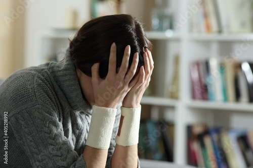 Photography Sad woman with bandages on wrists after suicide attempt