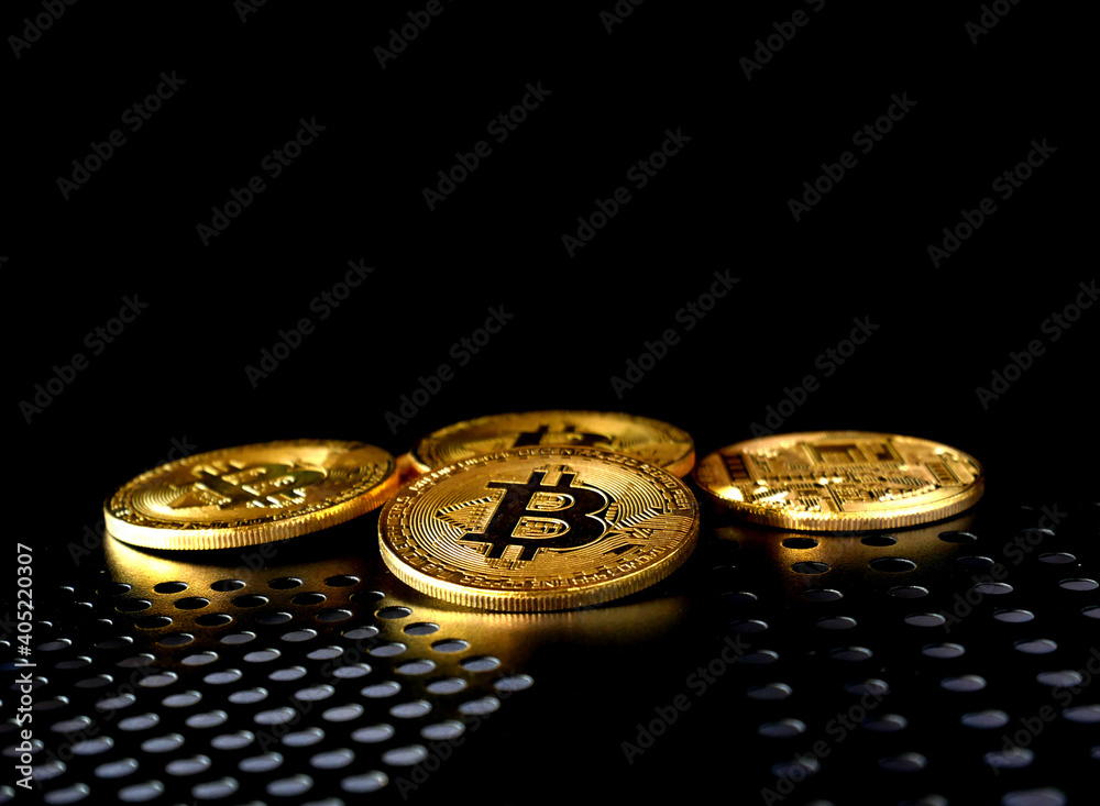 Close up of gold bitcoin on black background with selective focus Close up of gold bitcoin on black background with selective focus