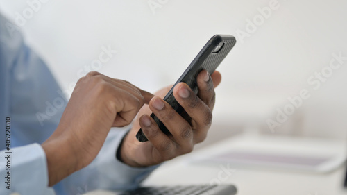 Hands of African Man Using Smartphone, Close Up 