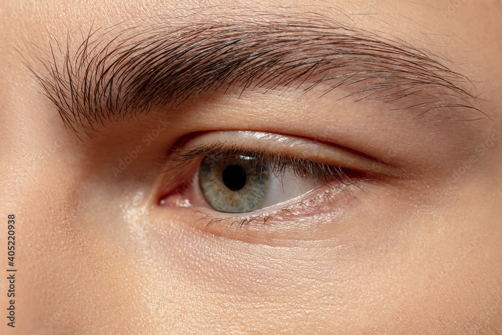 Obraz premium Eye sad. Close up face of young man on white studio background. Caucasian attractive male model. Concept of fashion and beauty, self-care, body and skin care. Handsome boy with well-kept skin.
