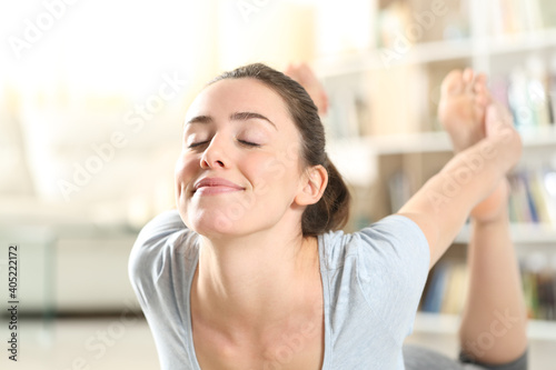 Free Download Woman doing yoga arc posture exercise at home - GFXLoad