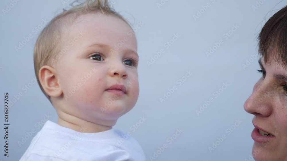 mom kisses baby. happy family little baby kid dream concept. mom kisses and hugs little newborn son. portrait of a little love newborn son mom kisses baby. happy family little baby kid dream concept. mom kisses and hugs little newborn son. portrait of a little love newborn son