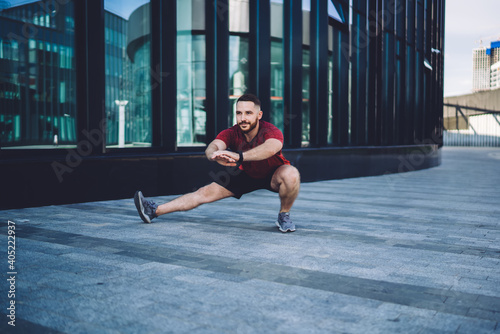 Man doing side lunge during workout
