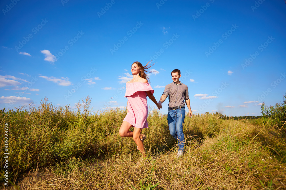 Shot of a young couple holding hands and running through the park. Shot of a young couple holding hands and running through the park.