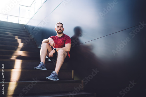 Young man sitting on stairs after training © BullRun