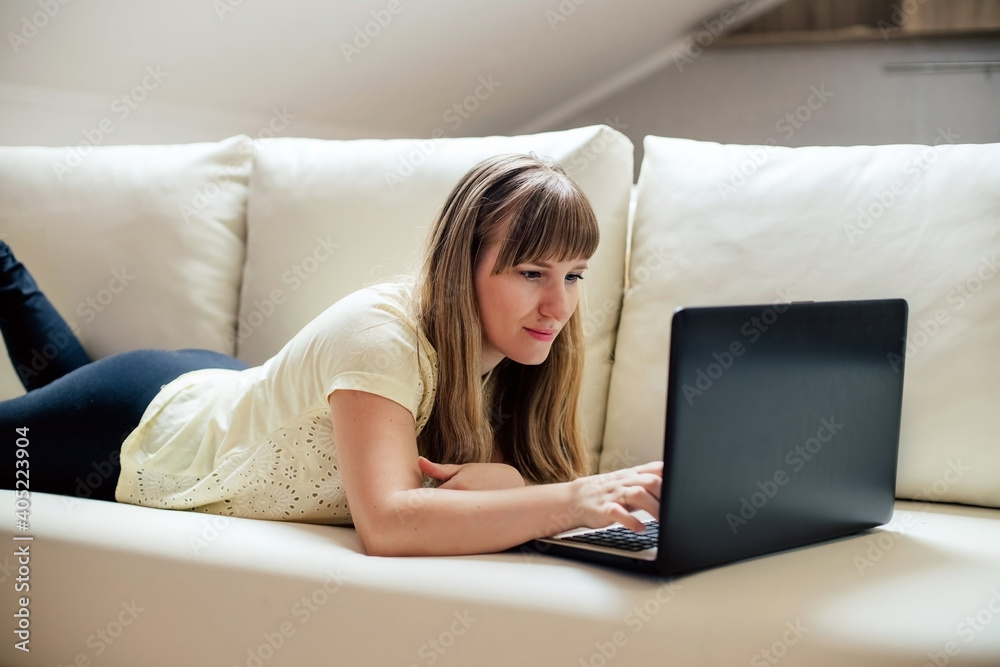 a young girl in light clothes is lying on the sofa a young girl in light clothes is lying on the sofa