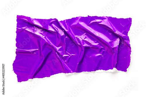 Torn and crumpled piece of purple glossy magazine paper isolated on white background. Copy space for text.