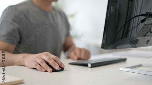Hands of Young Man Using Mouse and Keyboard, Close Up 