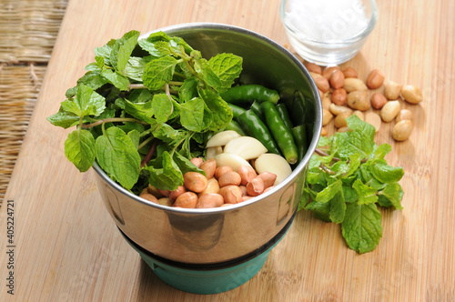 pudina or mint leaves, peanuts, garlic, green chillies in a mixer jar, ingredients for mint chutney