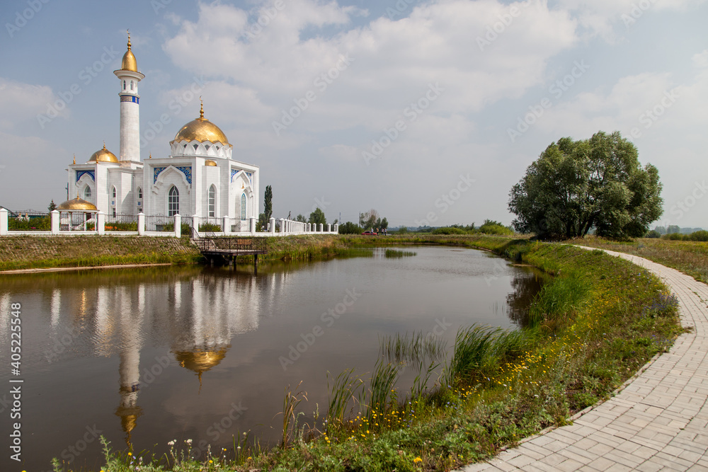 white mosque on the shore of the lake