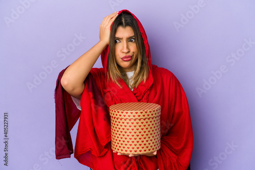 Young indian woman wearing a hijab holding a valentines day gift isolated being shocked, she has remembered important meeting.