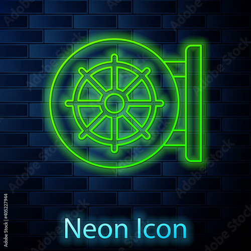 Glowing neon line Dharma wheel icon isolated on brick wall background. Buddhism religion sign. Dharmachakra symbol. Vector.
