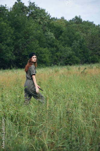 Woman in the meadow Walk in green jumpsuit black cap  © SHOTPRIME STUDIO