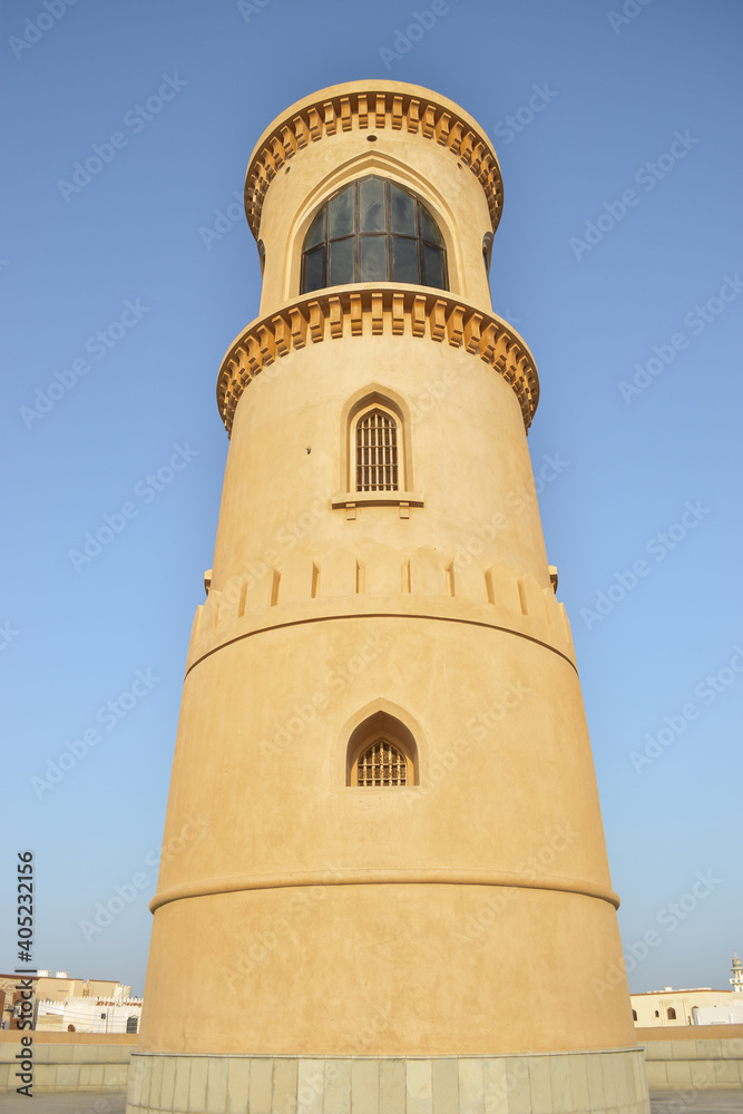 Beautiful and well conserved Al Ayjah lighthouse in contrast with the blue sky. Sur, Oman.