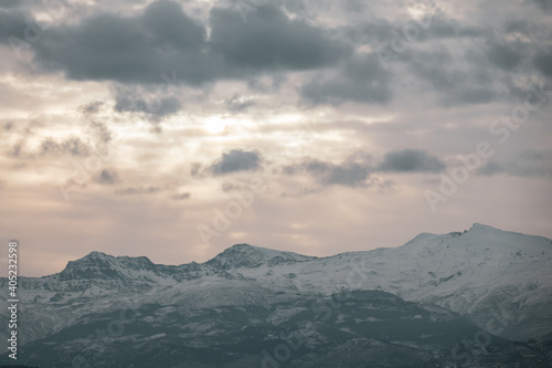 View of the highest peaks of Sierra Nevada  Granada  Spain  on a cloudy winter morning at sunrise