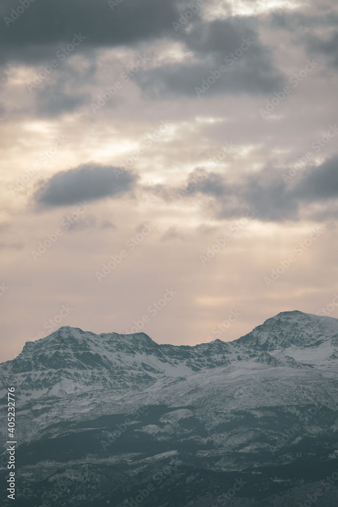 View of the highest peaks of Sierra Nevada (Granada, Spain) on a cloudy winter morning at sunrise