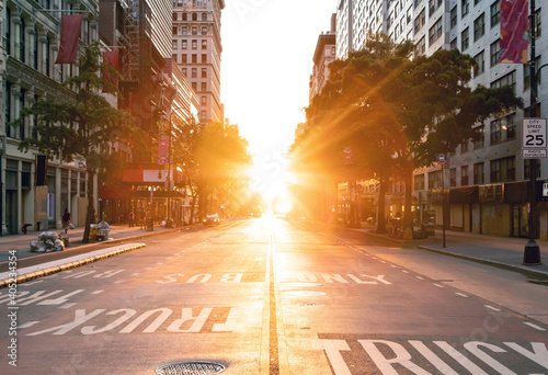 Sunset light shines over an empty view of 14th Street seen from Union Square Park in New York City photo