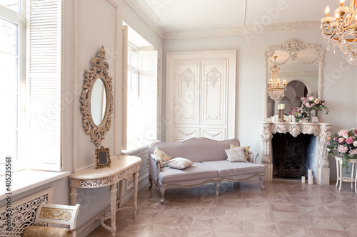 Luxurious light interior of the living room in the baroque style as in a royal castle with old stylish vintage furniture  columns  stucco on the walls
