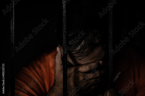 Asian man desperate at the iron prison,prisoner concept,thailand people,Hope to be free,Serious prisoners imprisoned in the prison