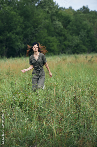 Woman in the meadow Tickets in green jumpsuit fresh air outdoor activities  © SHOTPRIME STUDIO