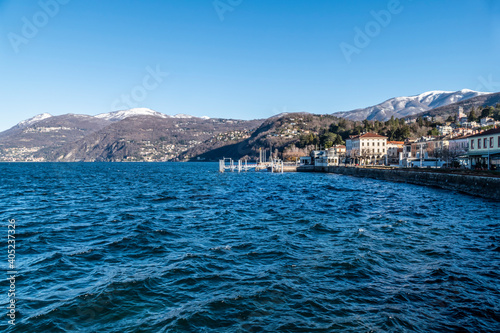 landscape of Luino and Lake Maggiore with snow-capped mountains in the background