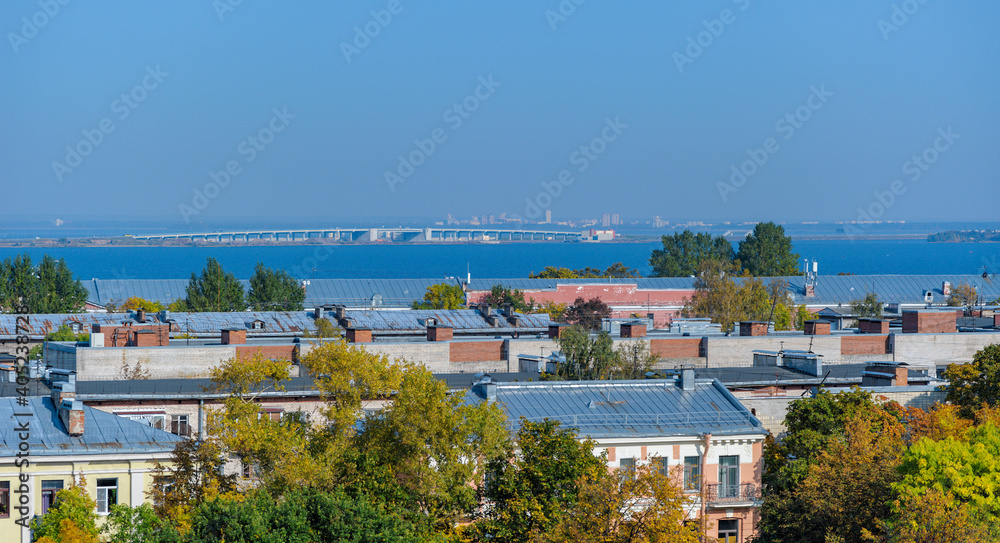 Rooftop Kronstadt view from belltower of Naval Cathedral of Saint Nicholas in golden autumn day with dam on background