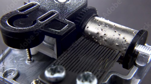 Close up shot with Mechanism of Musical box on black screen

