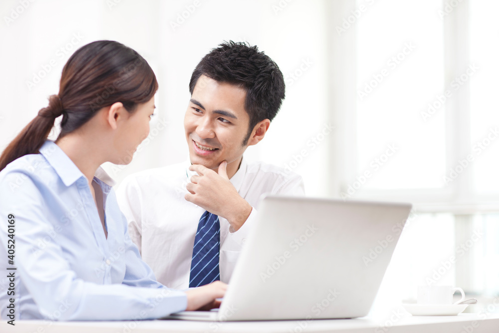 Businessman and businesswoman discussing working on computer Businessman and businesswoman discussing working on computer