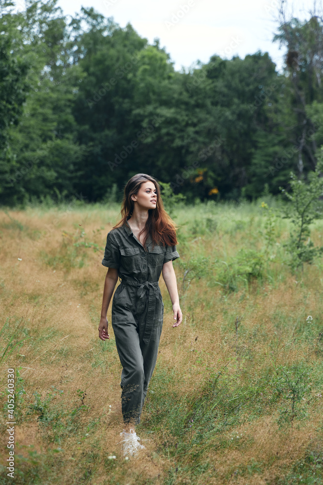 Woman in the forest dry grass gray jumpsuit Woman in the forest dry grass gray jumpsuit