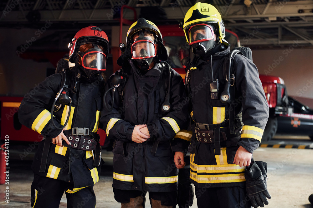 Group of firefighters in protective uniform that is on station Group of firefighters in protective uniform that is on station