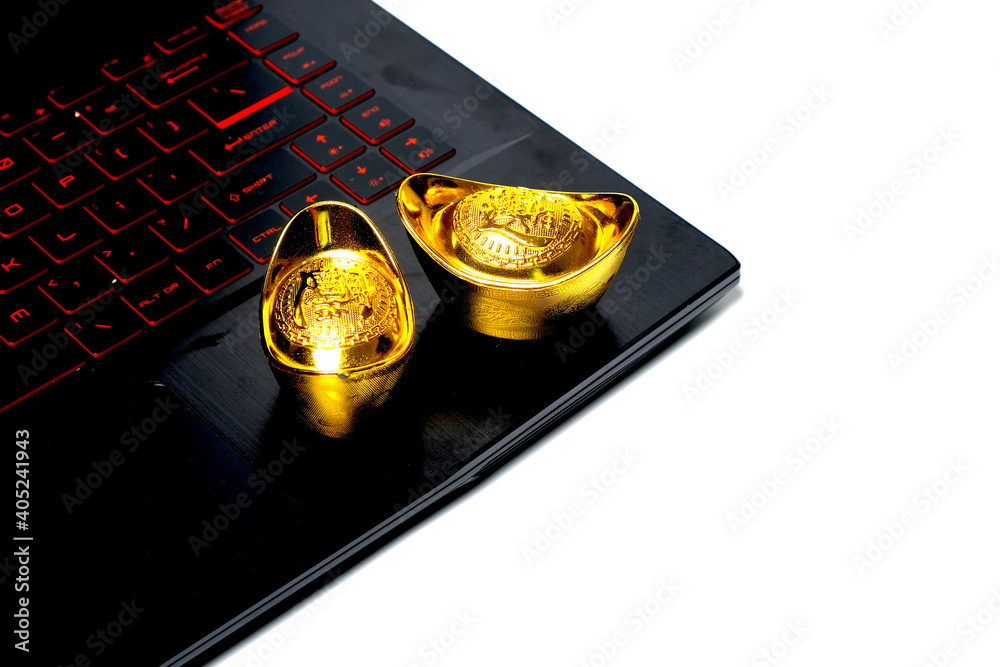 A picture of gold ingot written prosperity on laptop at white background. During covid-19 Chinese New Year will celebrate in new normal A picture of gold ingot written prosperity on laptop at white background. During covid-19 Chinese New Year will celebrate in new normal