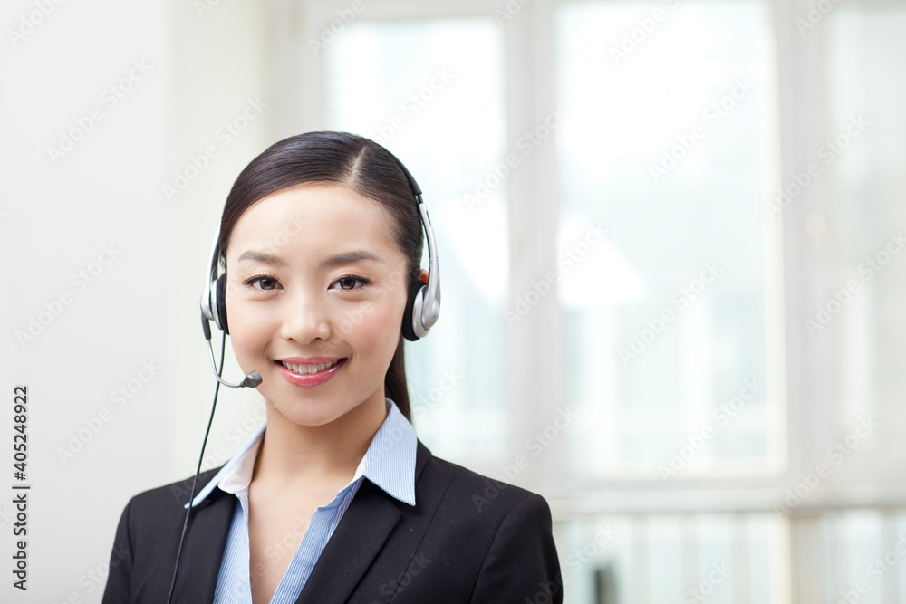 Young Female office worker wearing headset portrait Young Female office worker wearing headset portrait