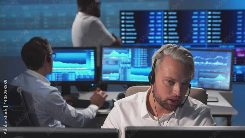 Diverse team of brokers workin in office using workstation and analysis technology. Workplace of professional traders. Global financial markets, business, currency exchange and banking concepts. Diverse team of brokers workin in office using workstation and analysis technology. Workplace of professional traders. Global financial markets, business, currency exchange and banking concepts.
