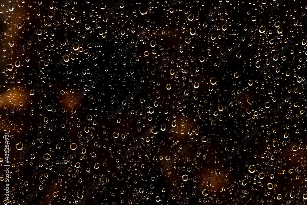 Fototapeta premium Raindrops on glass. Night rain