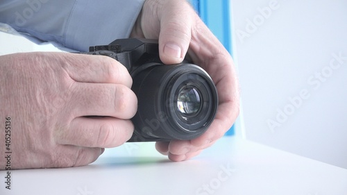 Photographer in a Photo Session Sets the Camera Focus for Taking a Picture