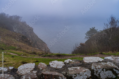 A view over the ocean from a steep hill a misty day. Picture from Kullen nature reserve, Scania county, Sweden