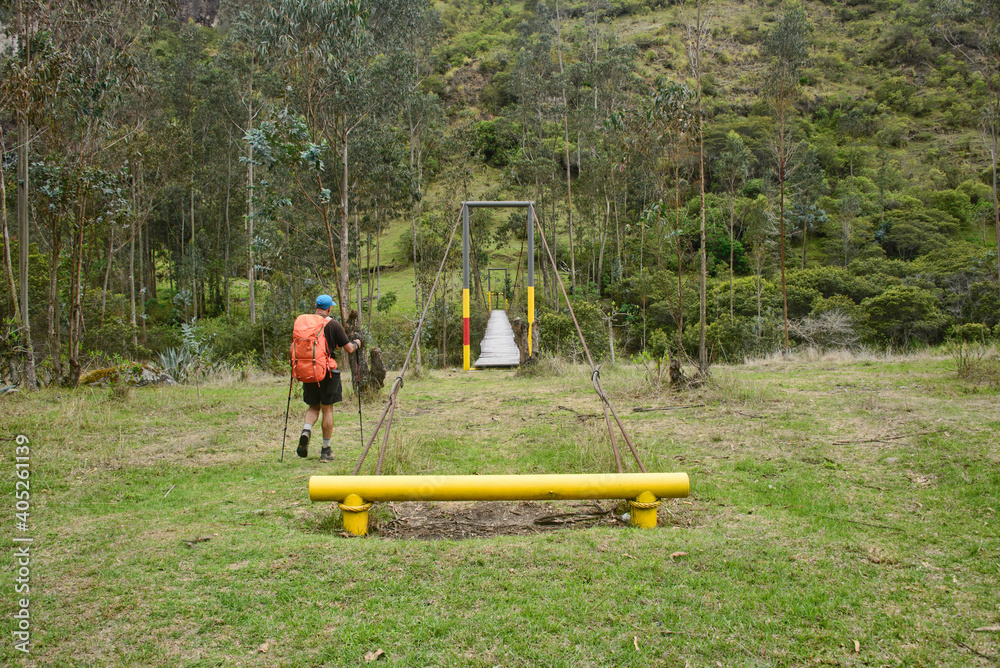 Fototapeta premium Wooden suspension bridge crossing over the Rio Toachi along the Quilotoa Loop Trek, Quilotoa, Ecuador