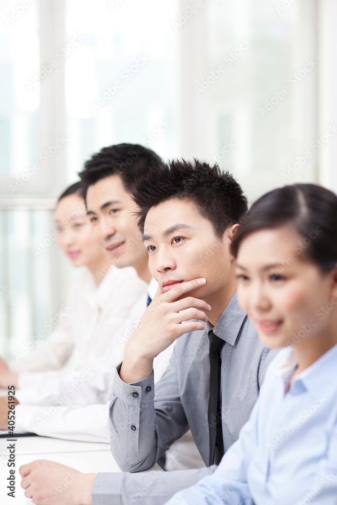 Group of business people sitting at conference table Group of business people sitting at conference table
