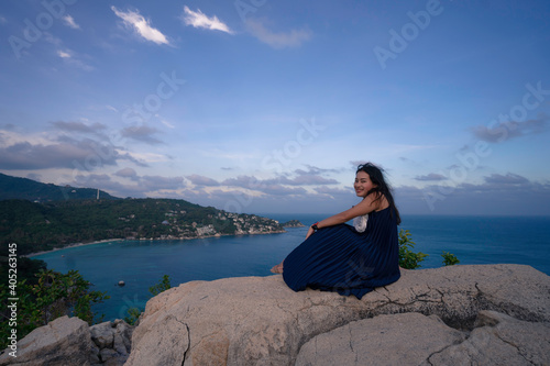 woman sit and relax on the rock at seascape view point, John-Suwan viewpoint at Koh Tao islands, place for tourist destination at Suratthani, Thailand