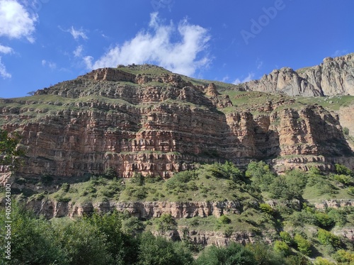 High, Green and brown sharp Mountains, cloudy blue sunny sky, shoot in Quba, Azerbaijan