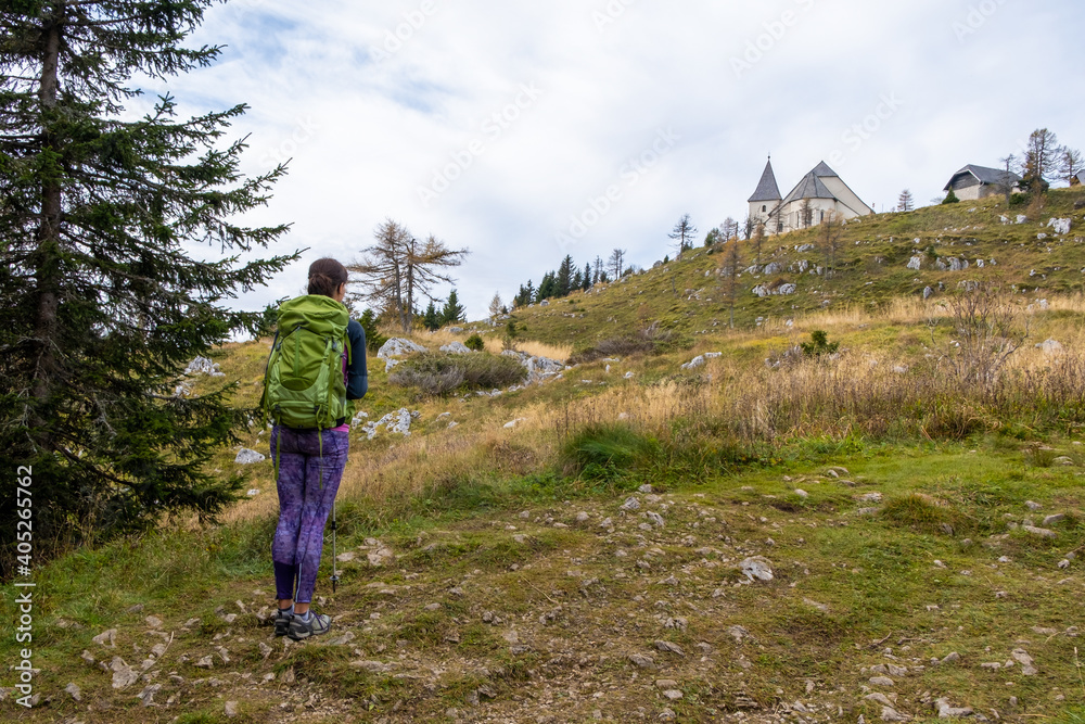 Fototapeta premium Woman hiker looking at Urslja gora or Plesivec in the Koroska region of Slovenia