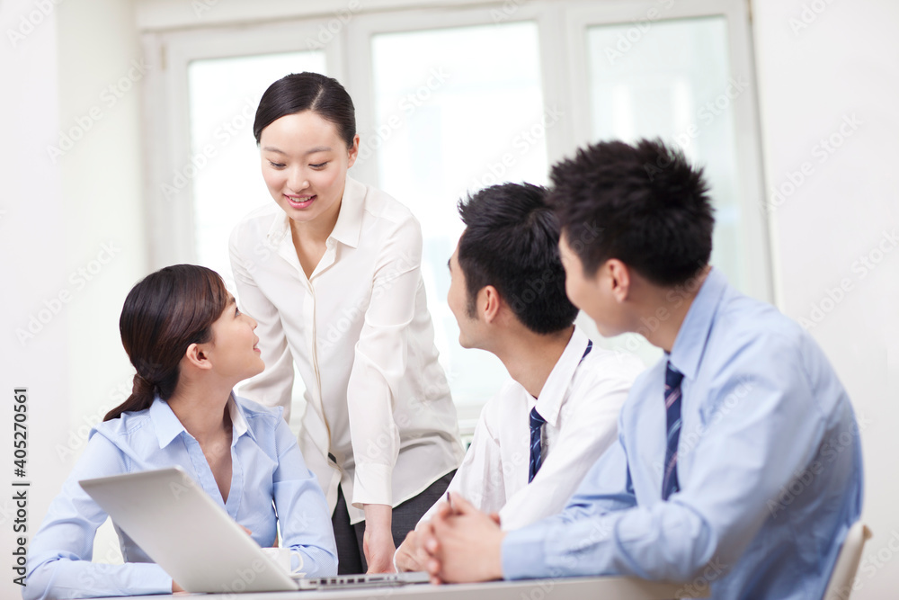 Group of businesspeople discussing working on computer