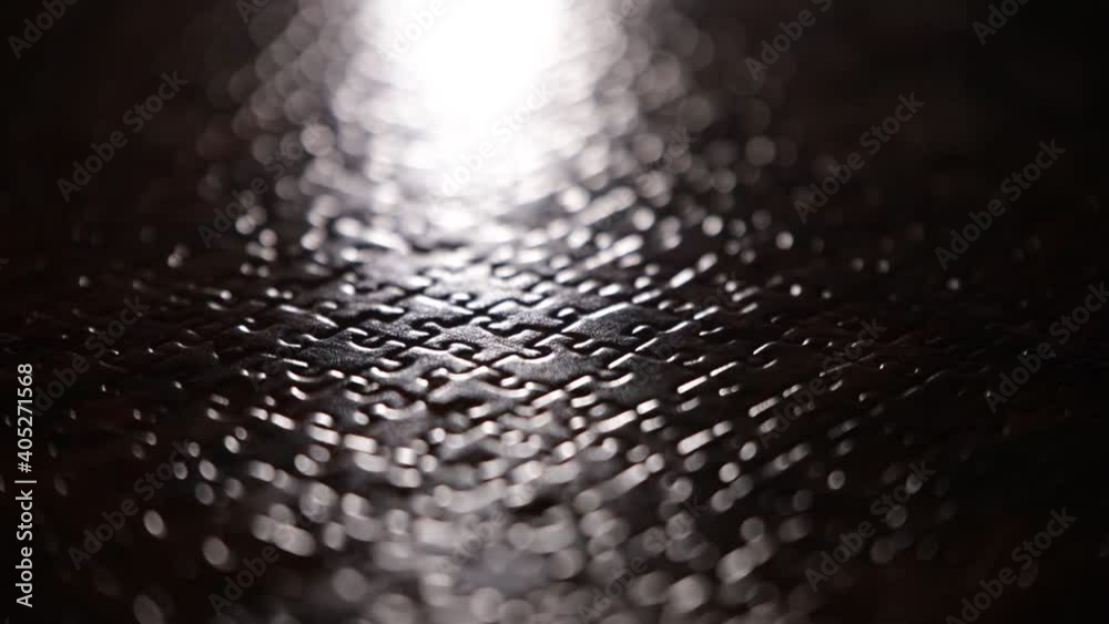 puzzle piece puzzling situation glow light centered movement moving from left to right shapes pieces almost black and white 