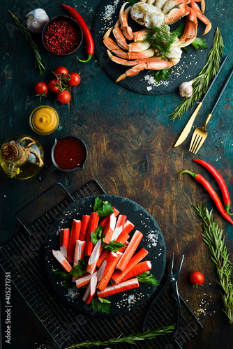 Canvas Print Crab sticks from a crab on a black stone plate