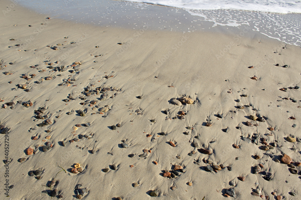 Pebble on sandy summer beach on peaceful Black sea coast meditating inspiring concept Pebble on sandy summer beach on peaceful Black sea coast meditating inspiring concept