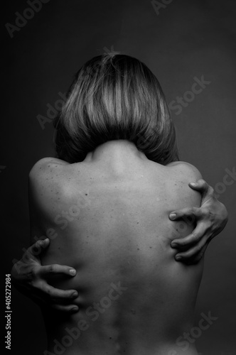 Black and white photo of a nude female back.